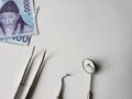 dentist utensils for oral review and south korean banknote of 1000 won