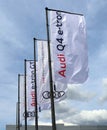 Promotional flags for the electric car model Q4 GT e-tron outside the Audi car dealership