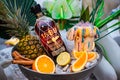 Promotional photography rum ice bowl palm leaves pineapple orange