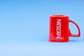Promotional red Nescafe mug on blue background