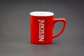 Promotional red Nescafe mug on dark background