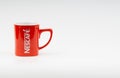 Promotional red Nescafe mug on white background