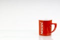 Promotional red Nescafe mug on white background