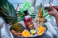 Promotional shot of rum bowl with ice pineapple orange hand of the bartender Royalty Free Stock Photo