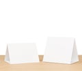 Promotional table talker isolated on wooden table white background with clipping path, mockup template paper