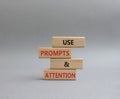 Prompts and Questions symbol. Concept word. Use Prompts and Questions on wooden blocks. Beautiful grey background. Business and Royalty Free Stock Photo