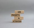 Prompts and Questions symbol. Concept word. Use Prompts and Questions on wooden blocks. Beautiful grey background. Business and Royalty Free Stock Photo