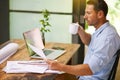 Proof reading the contract in the company of coffee. a young man working from home.