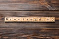 Proofreading word written on wood block. proofreading text on table, concept