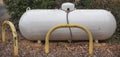 Propane liquid gas tank protected by bollards