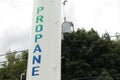 propane white vertical cylinder refill station with propane written on it