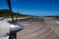 Propeller airplane detail taking off out of tropical paradise