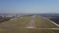 Propeller airplane taking off from airport runway on a sunny day, aerial shot Royalty Free Stock Photo