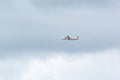 Propeller plane, ATR 72-600, of the Iberia airline flying in a sky with dark clouds shortly after take off