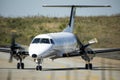 Propeller plane leaving the taxiway, heading towards the airport gates