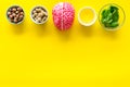 Proper nutrition for brain with nuts, spinage and oil stethoscope on yellow background top view copy space Royalty Free Stock Photo