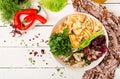 Dietary salad. Farfalle pasta durum wheat with baked chicken fillet with eggplant, zucchini and salad in bowl.