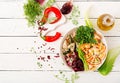 Farfalle pasta durum wheat with baked chicken fillet with eggplant, zucchini and salad in bowl.