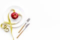 Proper nutrition for lose weight. Empty plate, apple and measuring tape on white background top view space for text Royalty Free Stock Photo