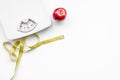 Proper nutrition for lose weight. Scale, measuring tape, apple on white background top view space for text Royalty Free Stock Photo