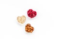 Proper nutrition for pathients with heart disease. Cholesterol reduce diet. Oatmeal, pomegranate, almond in heart shaped Royalty Free Stock Photo