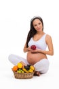 Proper nutrition during pregnancy. Vitamins and fruit. Pregnant women eating apple