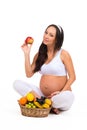 Proper nutrition during pregnancy. Vitamins and fruit. Pregnant women eating apple