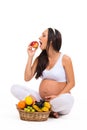 Proper nutrition during pregnancy. Vitamins and fruit. Pregnant women eating apple