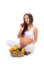 Proper nutrition during pregnancy. Vitamins and fruit. Pregnant women eating apple