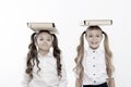 Proper posture. Schoolgirls with cute pony tails hairstyle carry folders on heads. Perfect schoolgirls with tidy fancy Royalty Free Stock Photo