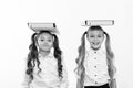 Proper posture. Schoolgirls with cute pony tails hairstyle carry folders on heads. Perfect schoolgirls with tidy fancy Royalty Free Stock Photo