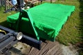 A properly covered pile of cut grass from the garden maintenance on the container is ensured by the transport and loading of the c Royalty Free Stock Photo