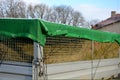 A properly covered pile of cut grass from garden maintenance on a trailer with a lattice superstructure for a larger capacity of t Royalty Free Stock Photo