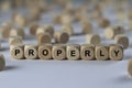Properly - cube with letters, sign with wooden cubes Royalty Free Stock Photo