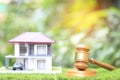 Property auction, Gavel wooden and model house on natural green background, lawyer of home real estate and ownership property