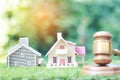 Property auction, Model house and Gavel wooden on natural green background, lawyer of home real estate and ownership property