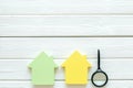 Property insurance concept with house toy and magnifier on white wooden background top view mockup Royalty Free Stock Photo