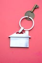 Property invest concept with key and ring on red background