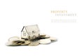 Property investment, silver golden house model on coins isolated Royalty Free Stock Photo