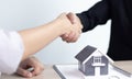 Property manager Shake hands with congratulations on the customers who bought the house with insurance