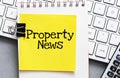 PROPERTY NEWS words on a small piece of paper