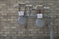 Exterior Natural gas meter gauge and pipeline on the tan brick wall Royalty Free Stock Photo