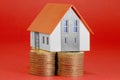 Property Tax on buildings - Property Real Estate concept with a small home model and euro coins group Royalty Free Stock Photo