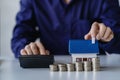 Property tax and market growth coins with stacks of coins on wooden table to show savings. Family plan. House. Loan Royalty Free Stock Photo