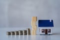 Property tax and market growth coins with stacks of coins on wooden table to show savings. Family plan. House. Loan Royalty Free Stock Photo