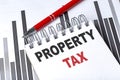 PROPERTY TAX text written on notebook with pen on chart Royalty Free Stock Photo