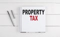 PROPERTY TAX text written on notebook on the wooden background Royalty Free Stock Photo