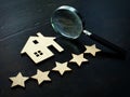 Property valuation and home appraisal. Model of house and five stars