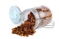 Propolis granules are scattered from a glass jar. Bee glue. Apitherapy.