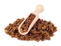 Propolis granules in a wooden shovel are isolated on a white background. Bee glue. Bee products. Apitherapy.